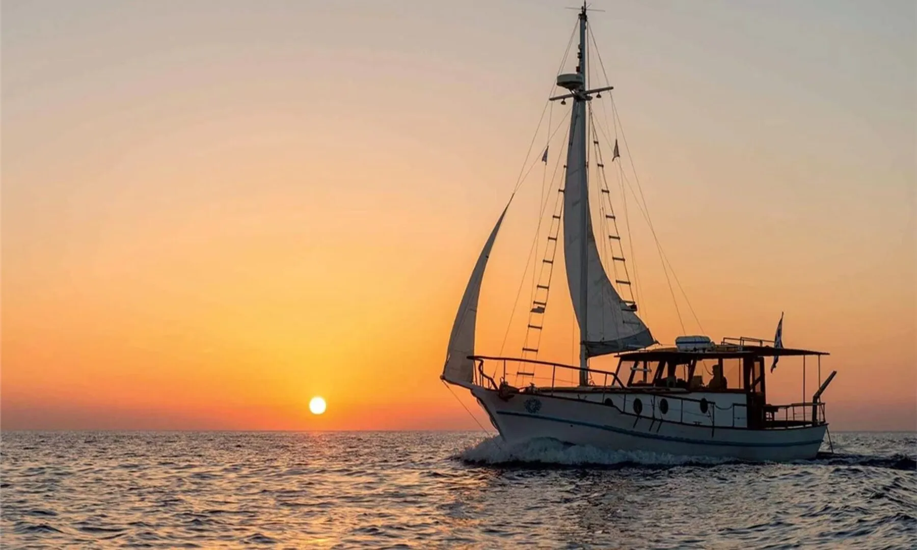 Cruise boat at sunset in Santorini