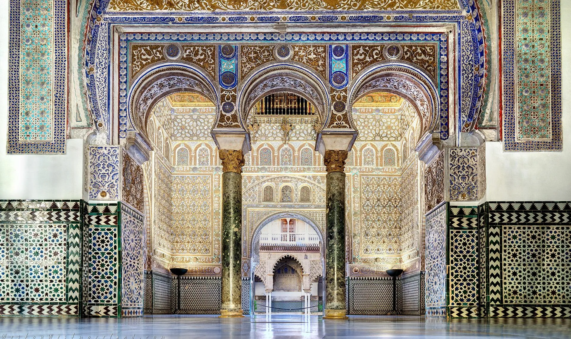 Mudéjar doorway with geometric tile mosaics and carved stucco at the Alcázar