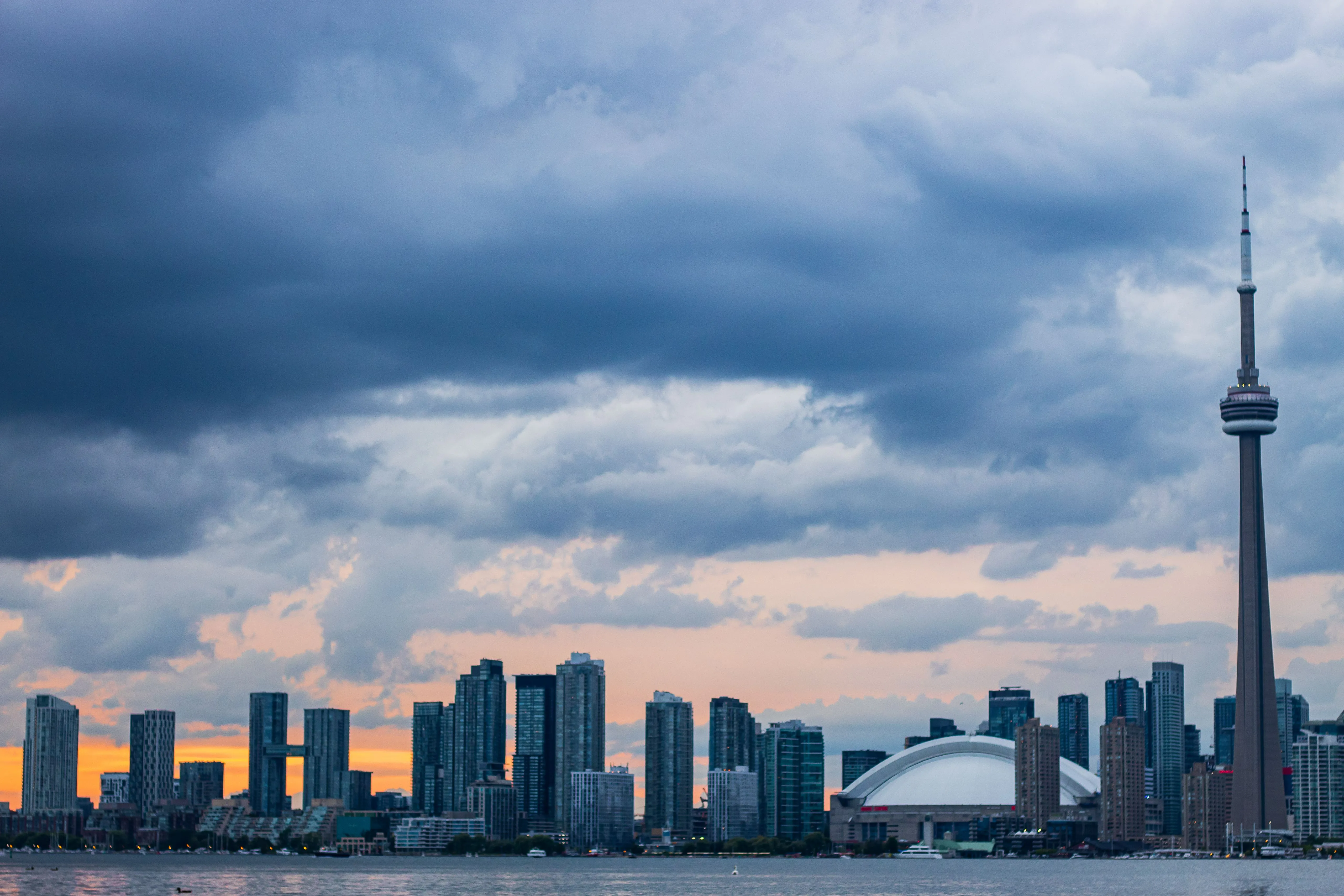 Toronto skyline glowing at sunset near the waterfront