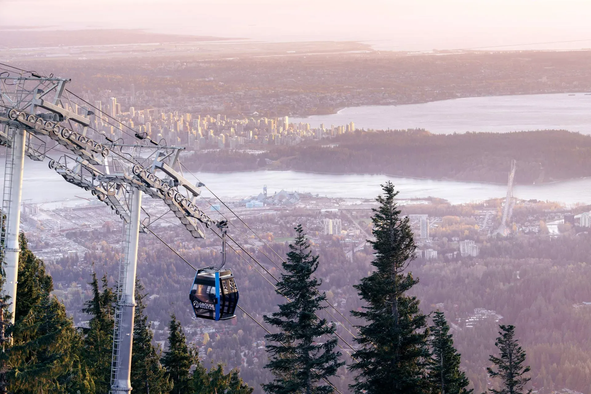 Skyride cabin above snowy slopes with Vancouver in the background