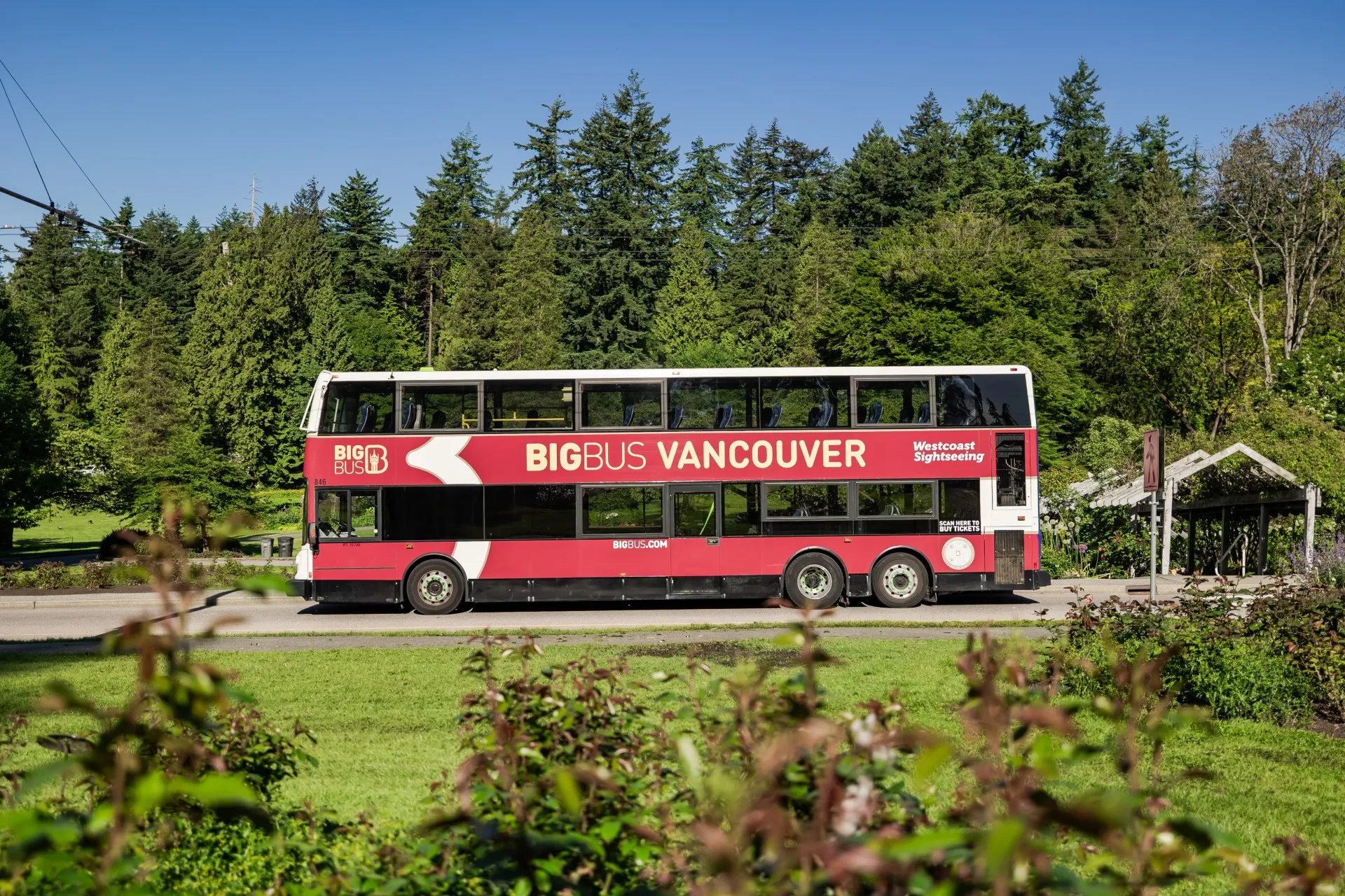 Open-top tour bus passing landmarks
