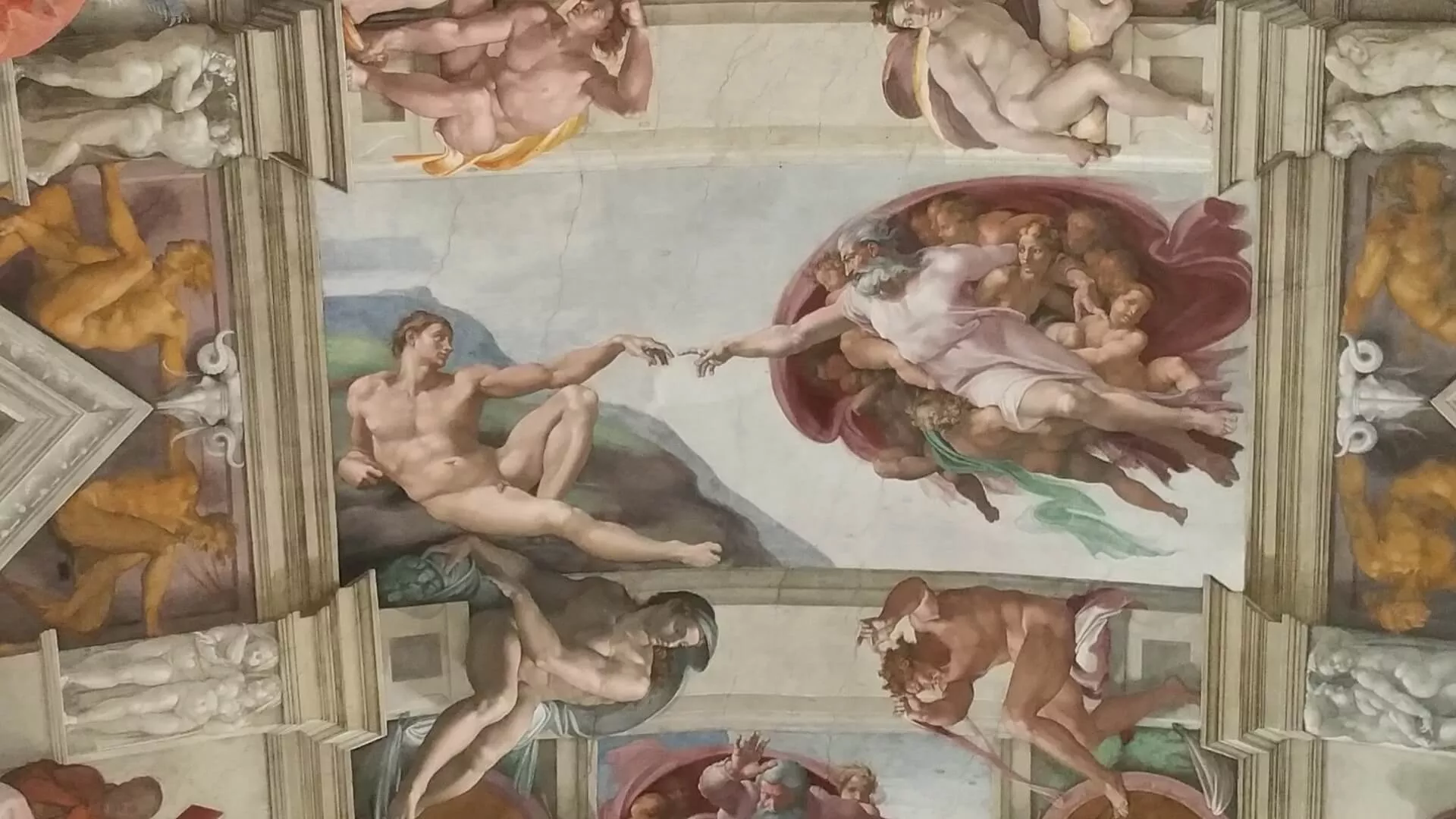 Detail of God and Adam touching fingers in the Sistine Chapel ceiling