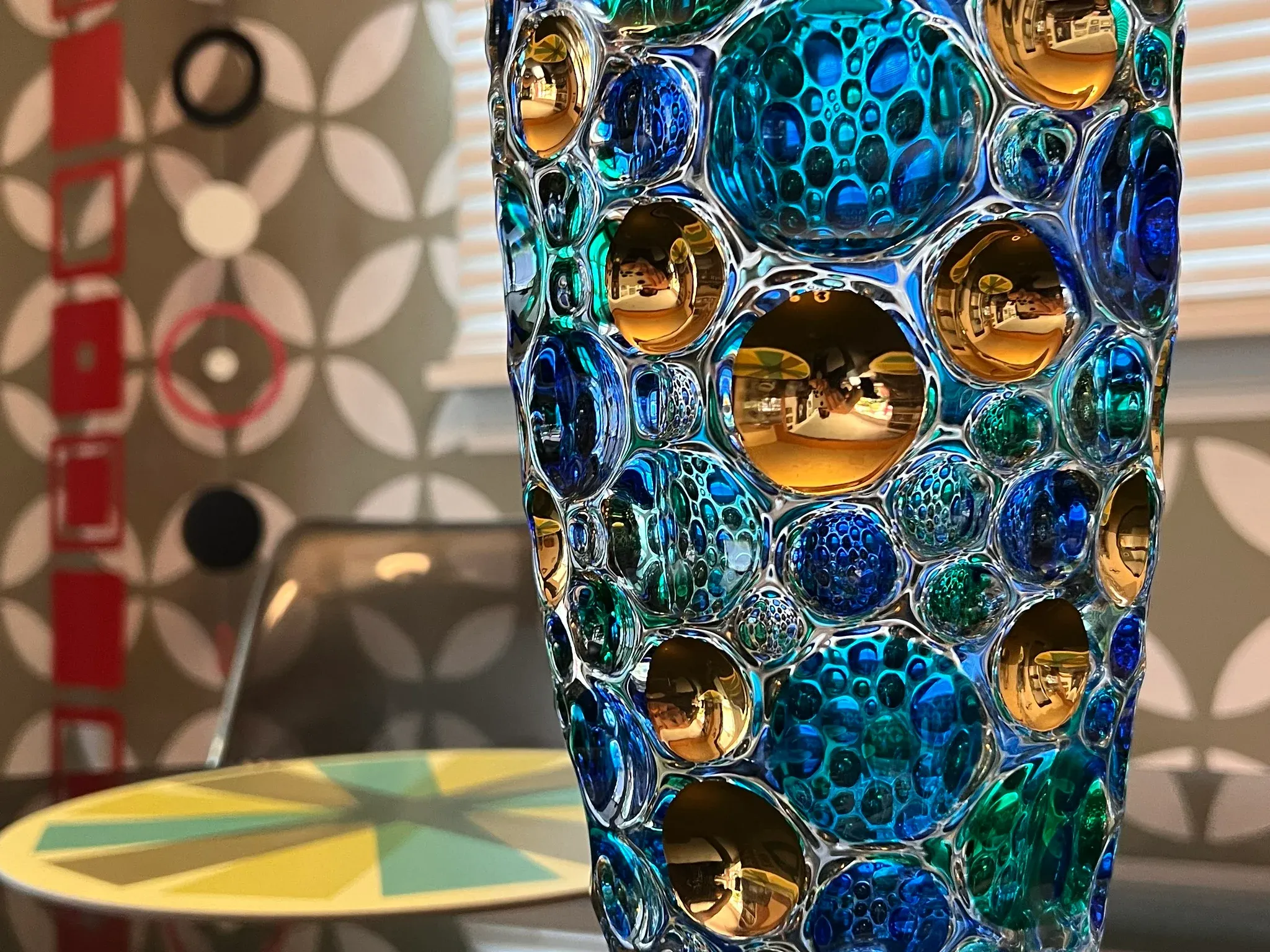 Close view of millefiori slices showing colorful floral patterns in glass