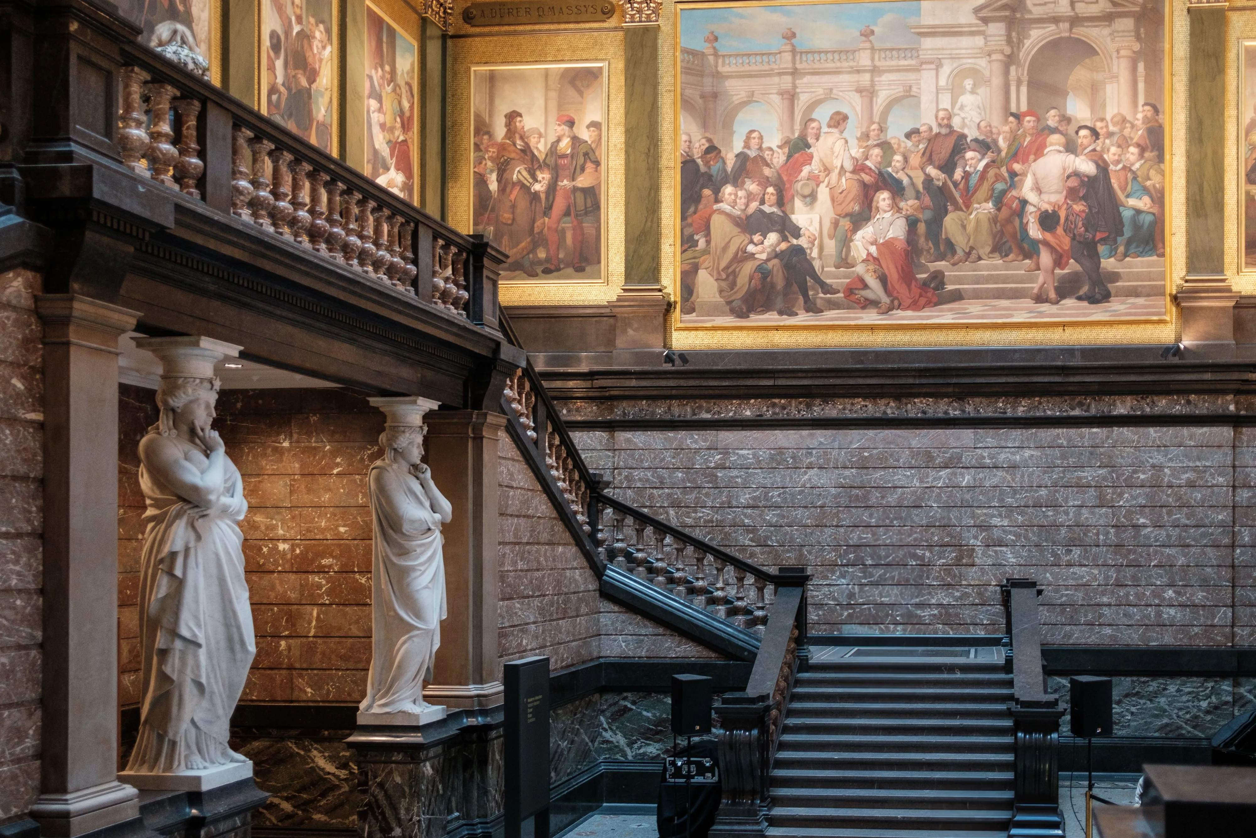 Museum staircase with marble statues