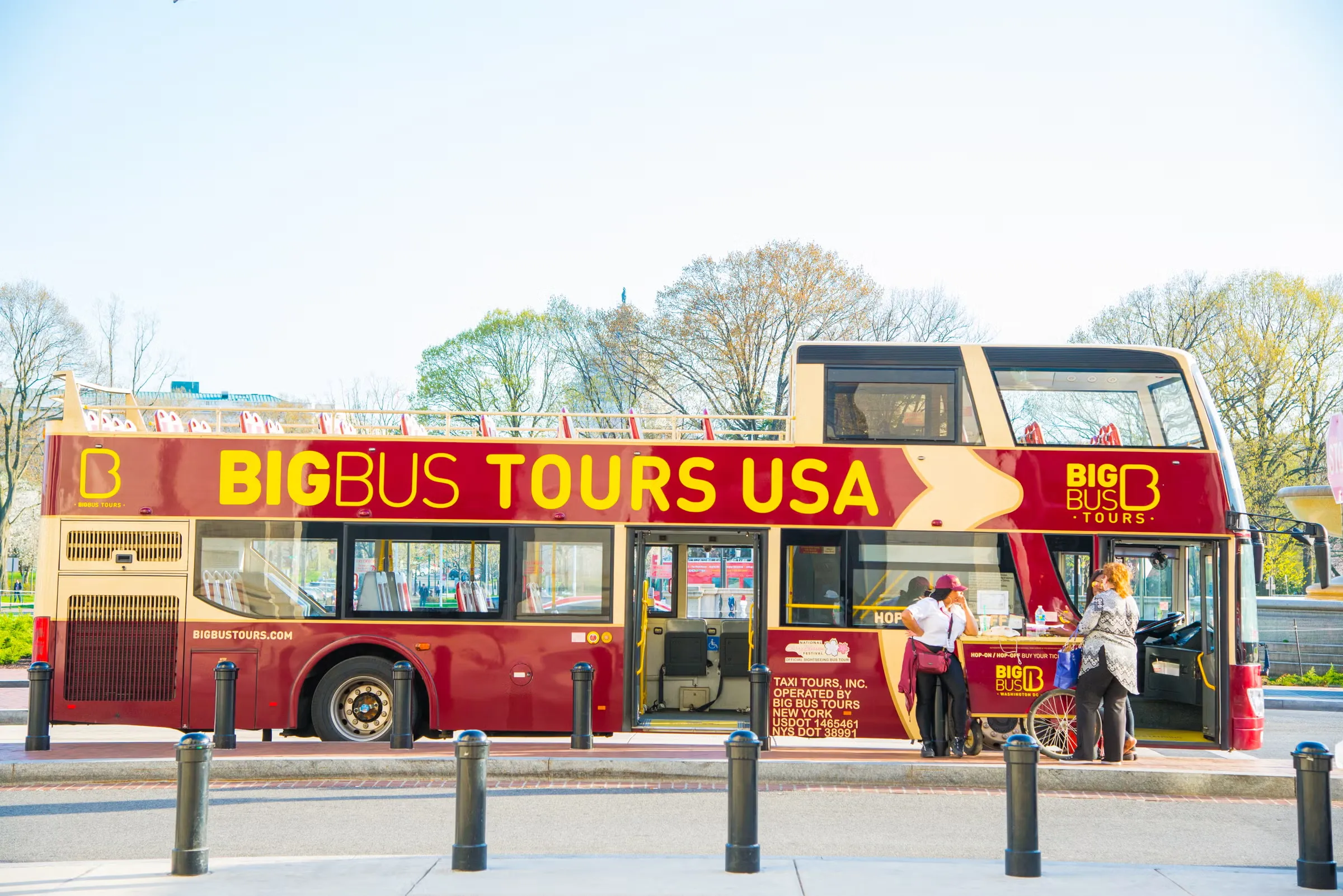 Big bus at a city stop with historic buildings
