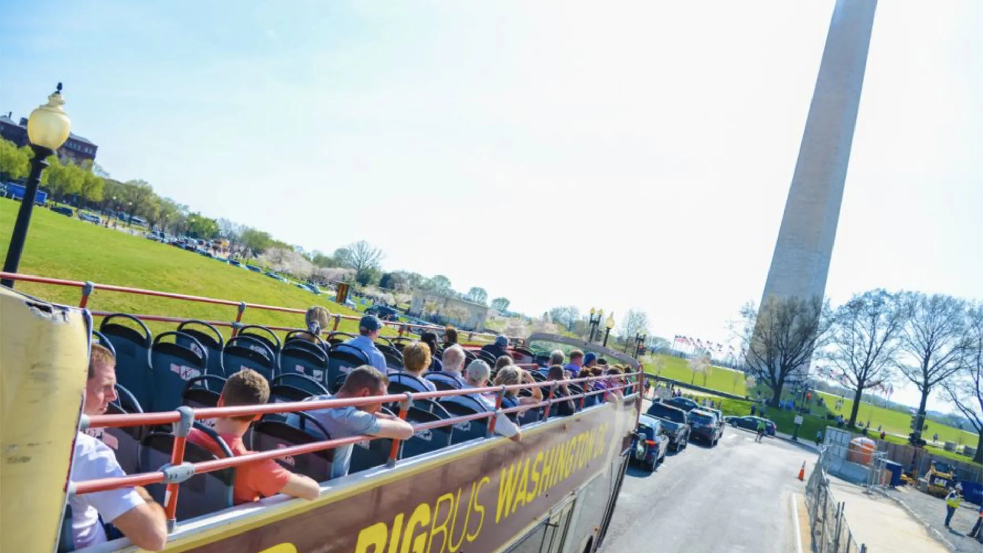 Passengers on the bus roof with the Washington Monument